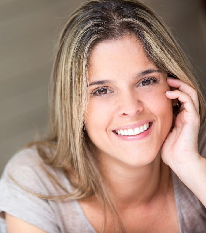 magnolia-family-dental-expert-cosmetic-dentistry Smiling woman with bright, healthy teeth posing indoors.
