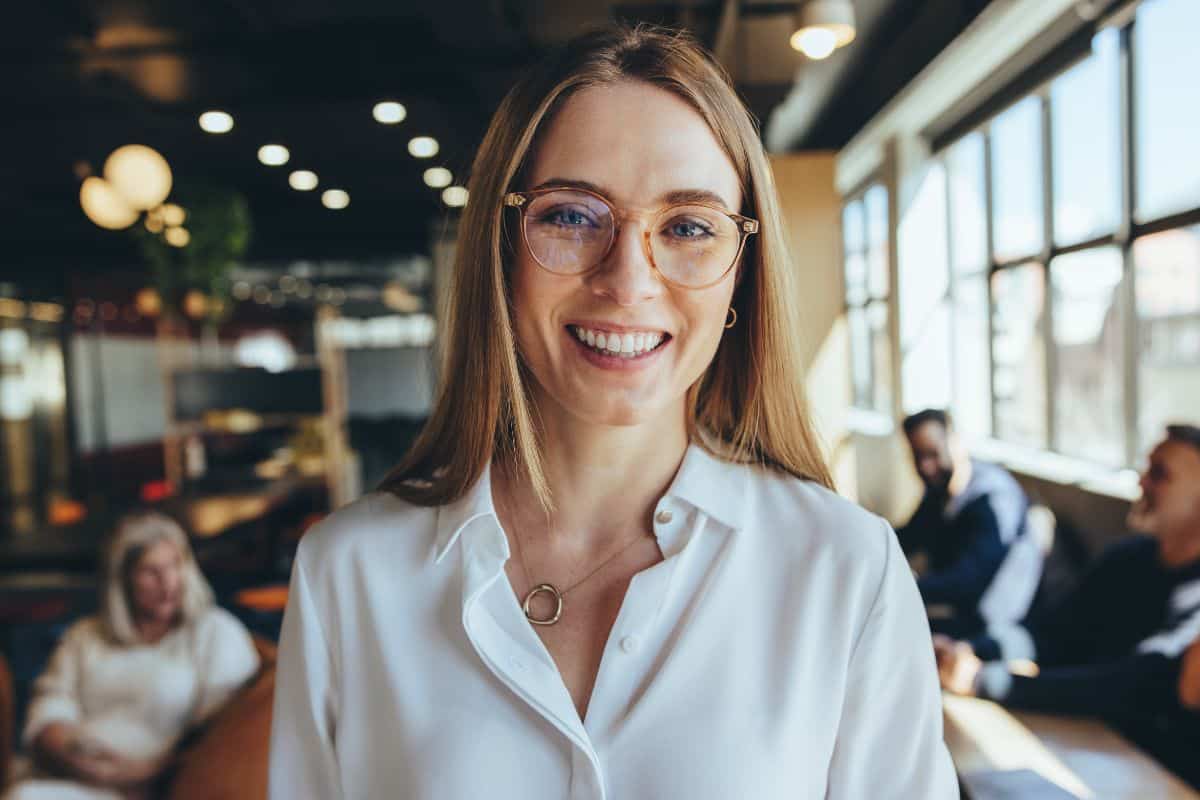 Friendly dental office team member smiling in a welcoming reception area