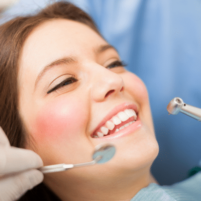 Woman at the dentist smiling, representing preventative dental care