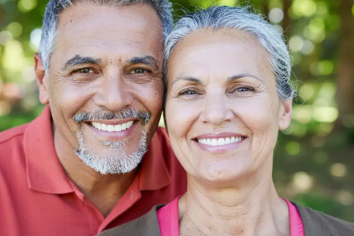 Magnolia-family-dental-implant-crowns Smiling older couple showing healthy teeth after restorative dentistry in midlothian va at magnolia family dental